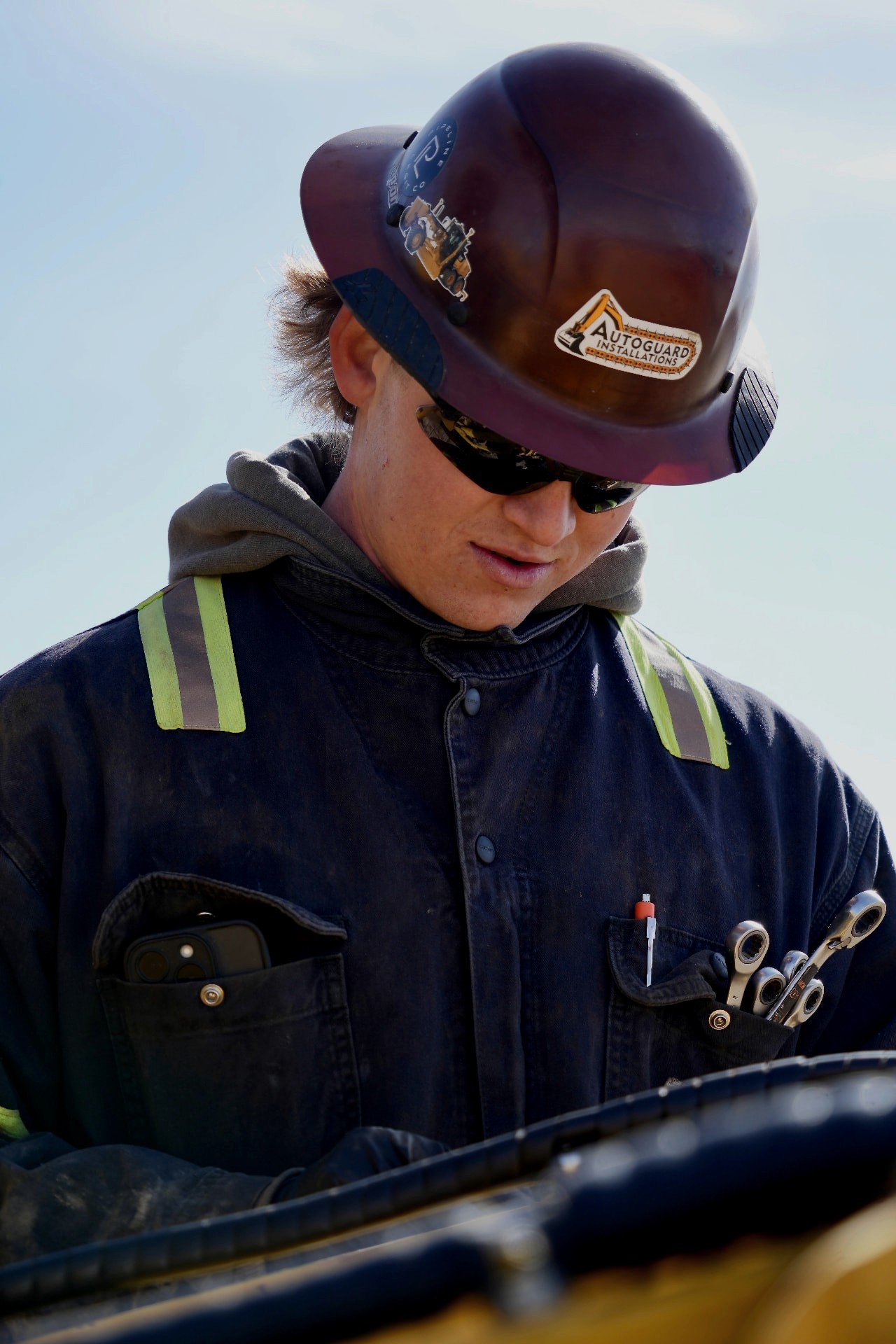Caden Cope, owner-operator of AutoGuard Installations, inspecting equipment on an Idaho jobsite